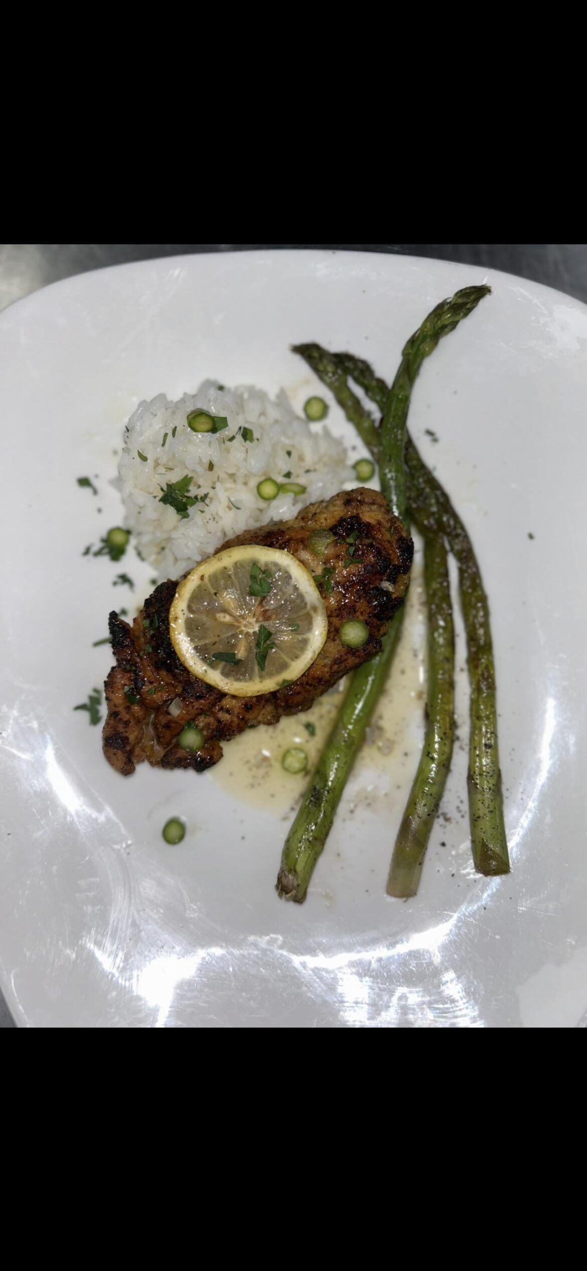 Lemon chicken with rice and roasted asparagus.