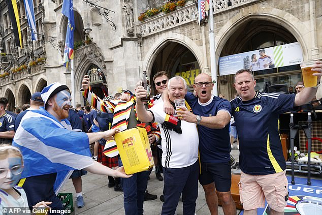 Supporters of Scotland and Germany cheer at the Marienplatz city square in Munich today