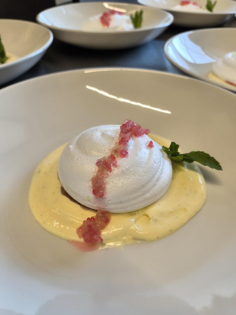 Rhubarb Lime Pavlova - crisp meringue, rhubarb compote filling, vanilla-saffron sabayon, finger lime caviar