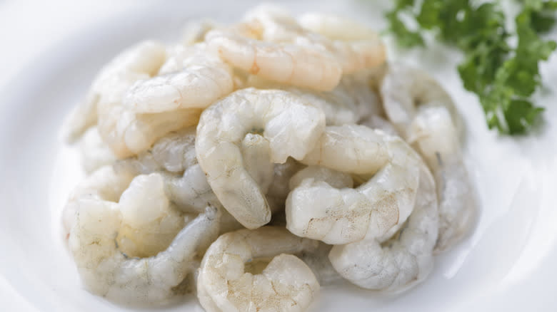 cleaned and prepped raw shimp on white dish