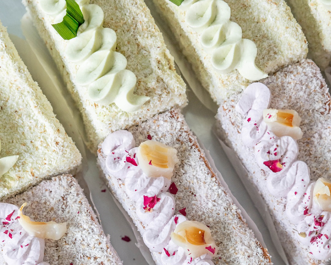 A lush lineup of green and pink gluten-free lamingtons from Folds Patisserie.