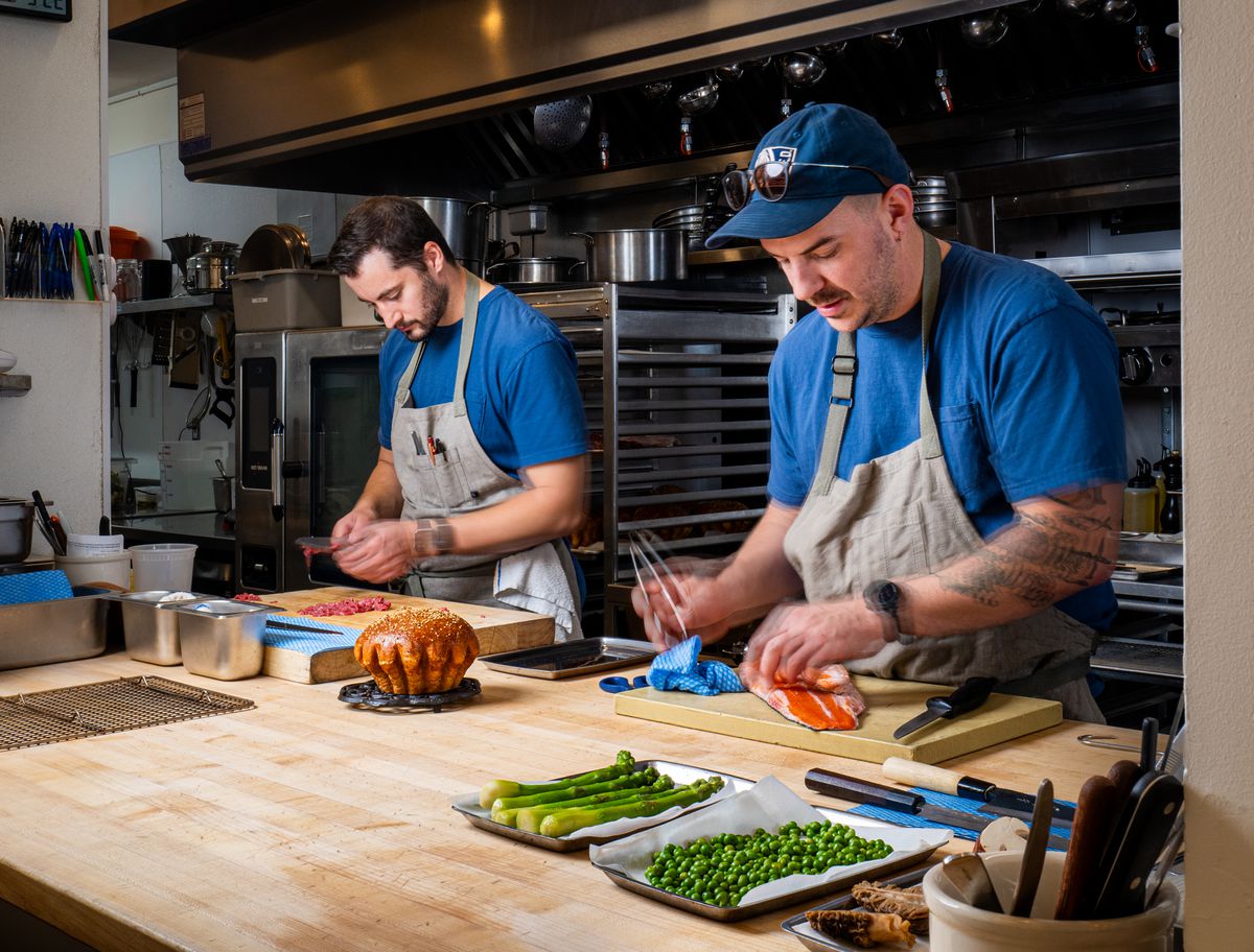Two chefs in the kitchen prepping food at Bistro Lagniappe in Healdsburg, California.