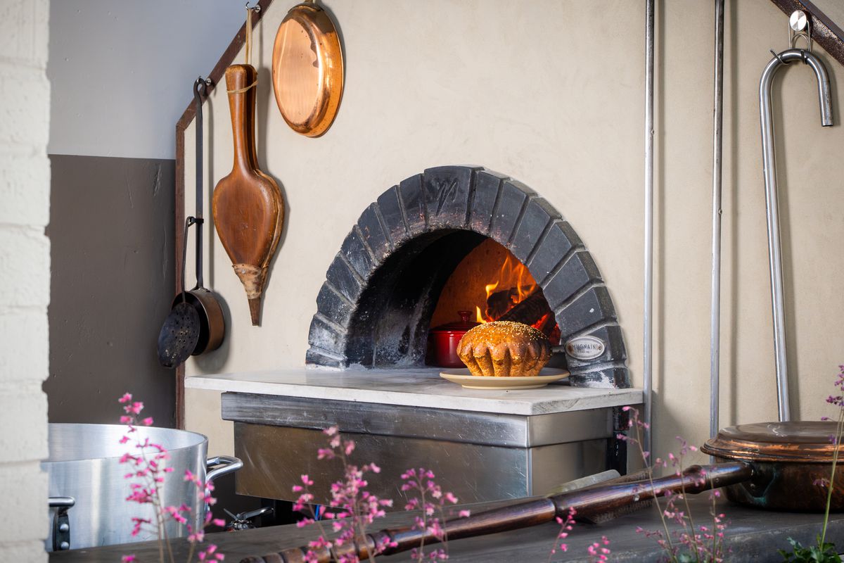 The wood-fired oven with a loaf of bread in front at Bistro Lagniappe in Healdsburg, California.