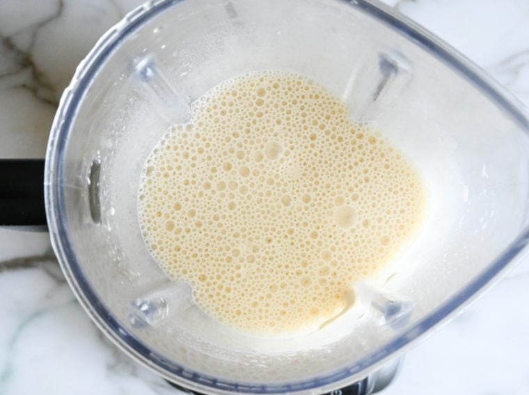 adding butter and blending crepe batter.