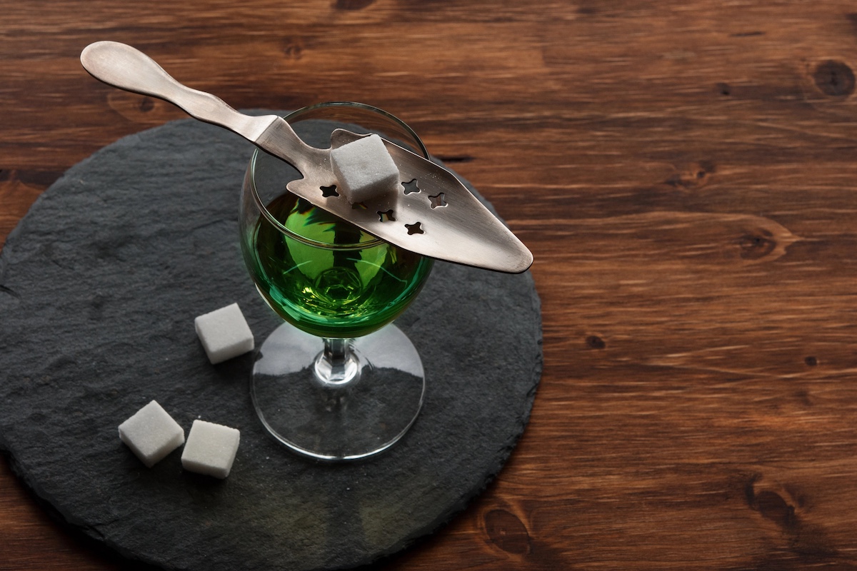 Glass of absinthe with absinthe spoon and sugar cubes