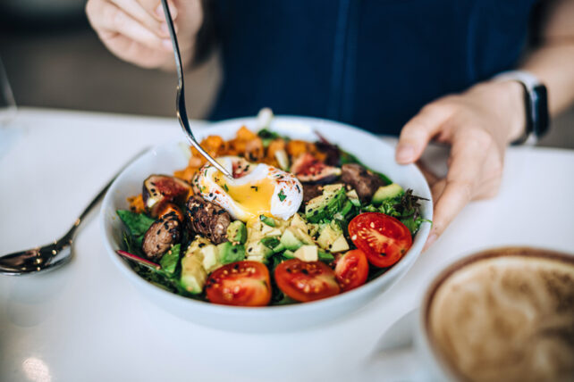 Salad with egg, tomatoes, avocado and greens