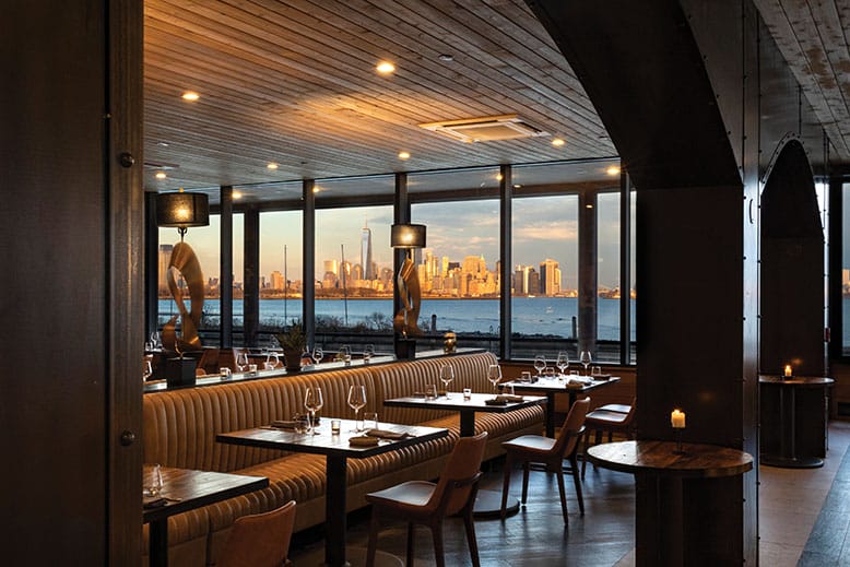 The dining room at Felina Jersey City, with a view of the Manhattan skyline