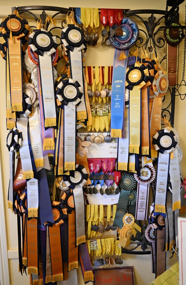 Numerous awards are piled on display in the visitors center at Il Fiorello Olive Oil Company in Fairfield. (Chris Riley/The Reporter)
