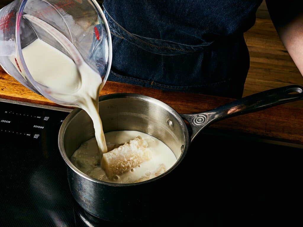 Poaching salt cod in milk.