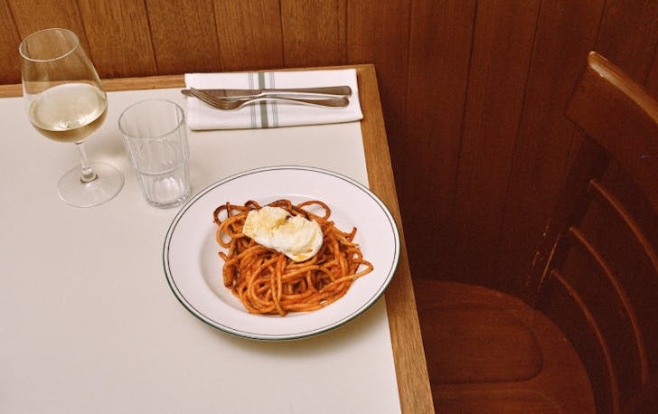 A plate of pasta on a table at one of the best Italian restaurants in Melbourne CBD.