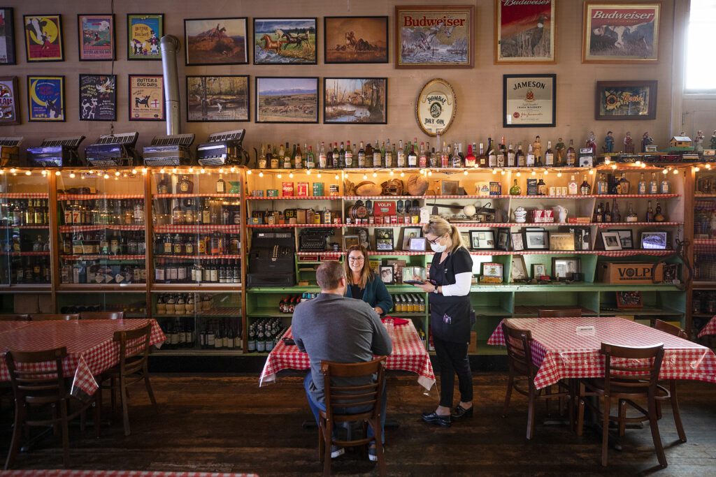 Wanda Lou takes an order from Pilar Marin and Andrew Reece on the opening night at Volpi's Ristorante & Bar in Petaluma after a year's hiatus since the start of the pandemic on Thursday, May 6, 2021. (Photo by John Burgess/The Press Democrat)