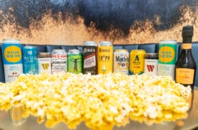 alcoholic drinks lined up with popcorn in foreground