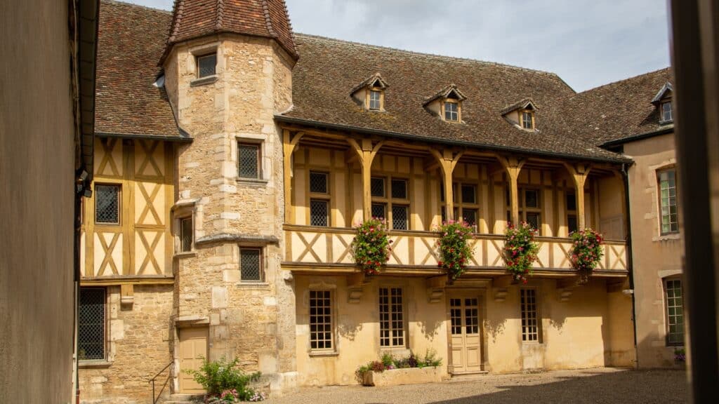 A photograph capturing Musee du Vin in Beaune, France. The image showcases the exterior of the museum, highlighting its architectural features and signage. 