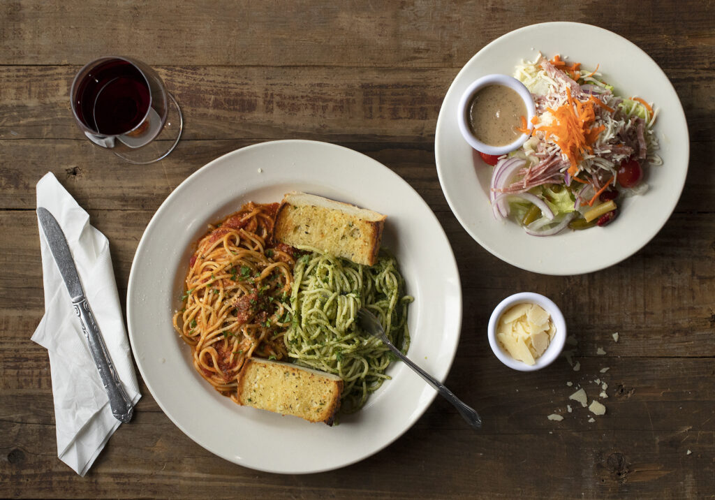 The famous Spaghetti Half & Half with marinara and pesto and a half order House Salad from Art's Place in Rohnert Park on Friday, Dec. 4, 2020. (John Burgess/The Press Democrat)