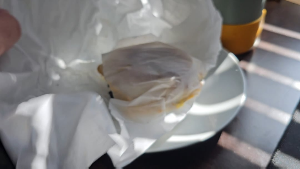 Unwrapping a sausage egg and cheese English muffin I made this morning.