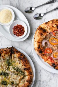 Wood-fired pizzettes pop with creative flavor combinations.