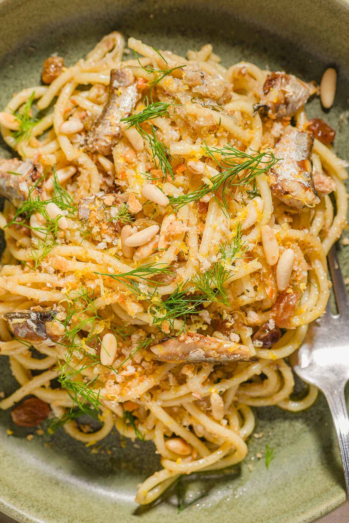 Sardine pasta in a bowl with a fork.