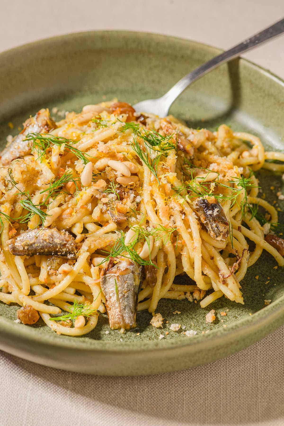 Sardine pasta in a bowl with a fork.