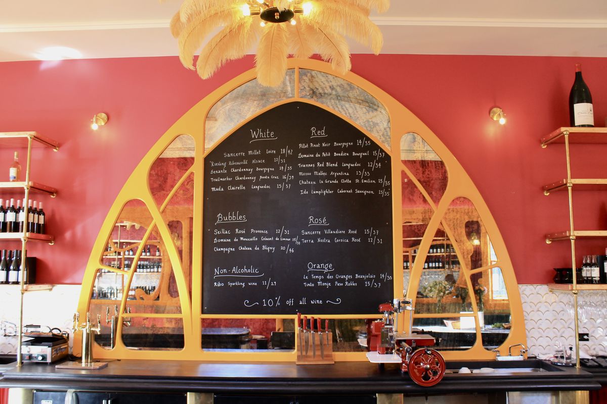 A chalkboard with a menu of wines on it.