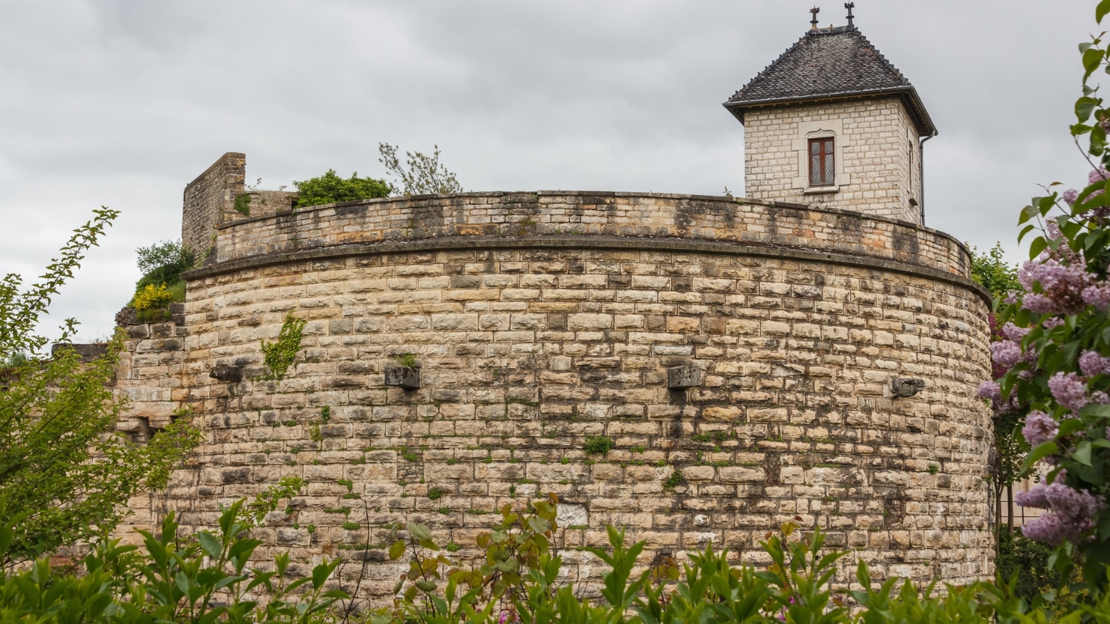  A photograph capturing the Remparts de Beaune in Beaune, France. The image showcases the fortified walls, a historical architectural feature of the town. 