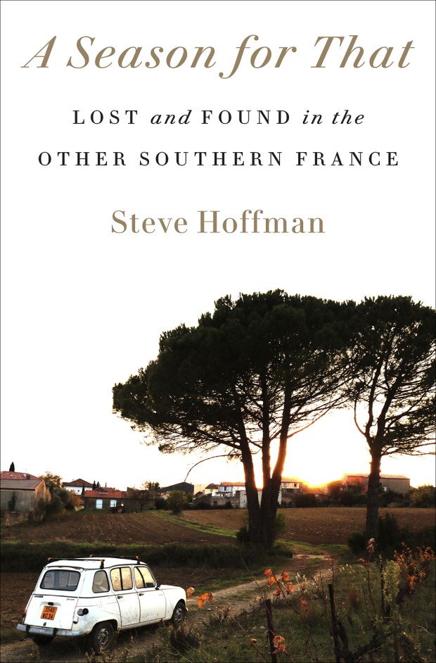 A book cover with a tree and a white car driving down the road