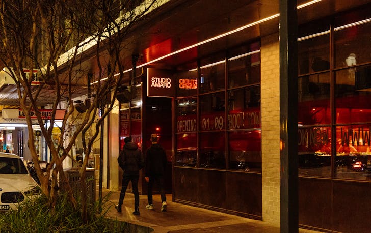 Two people walking on a footpath past Studio Amaro, one if the best Italian restaurants Melbourne has to offer