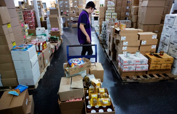 Yehuda Fishman, a driver for Miami Kosher Ko-Op, sorts kosher items on Monday, May 19, 2025. The nonprofit offers kosher food at heavily discounted prices by selling in bulk and not taking a profit. (Carline Jean/South Florida Sun Sentinel)