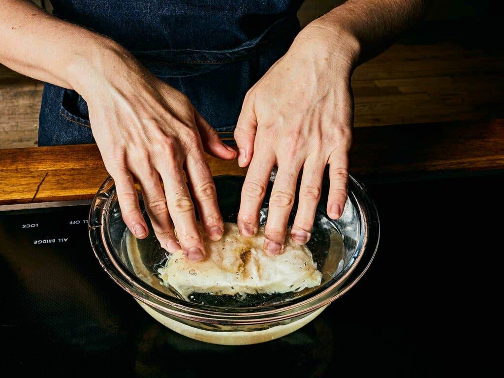 Soaking salt cod in cold water.