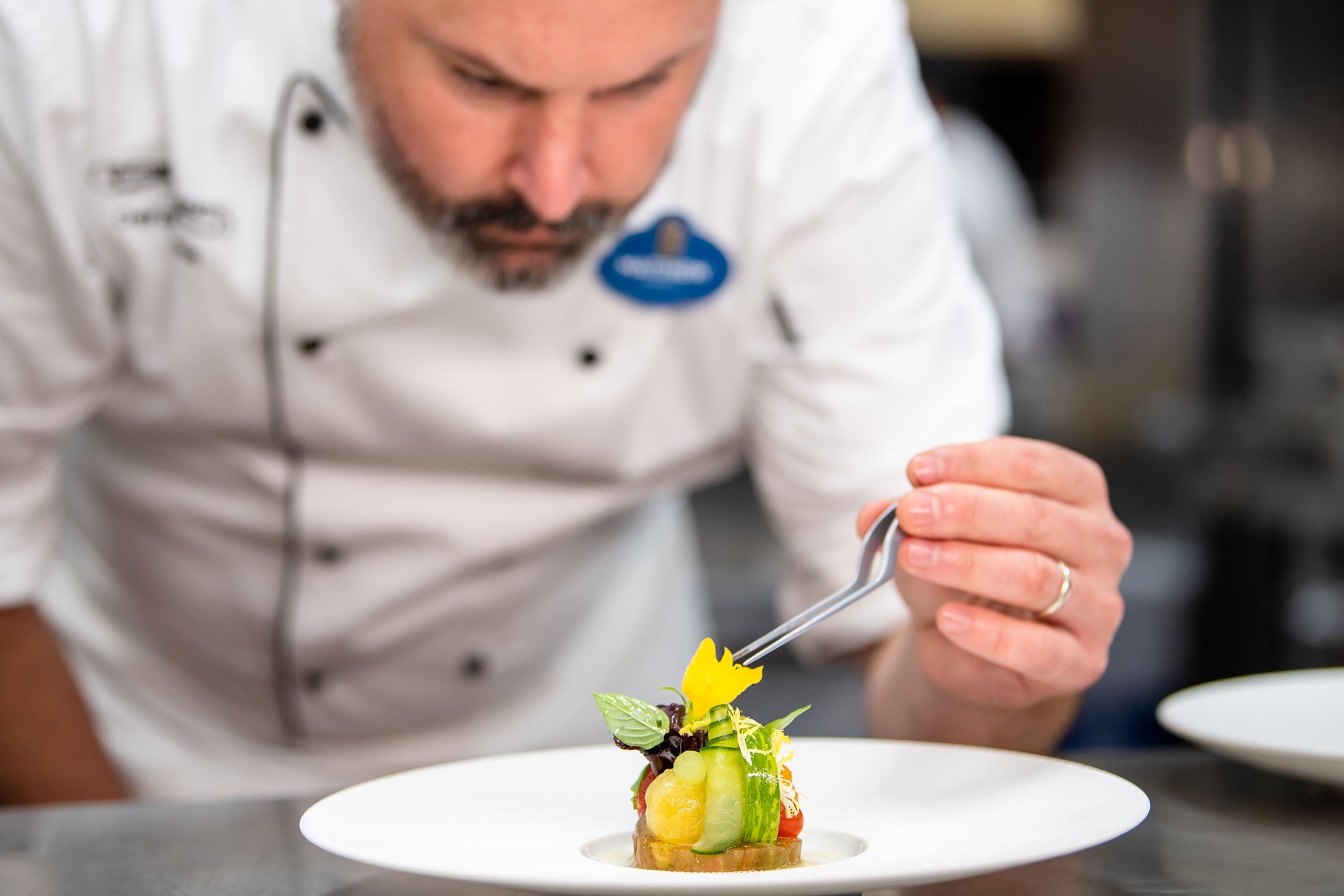 A Victoria & Albert’s chef applies the finishing touch to one of the restaurant’s Michelin-starred dishes