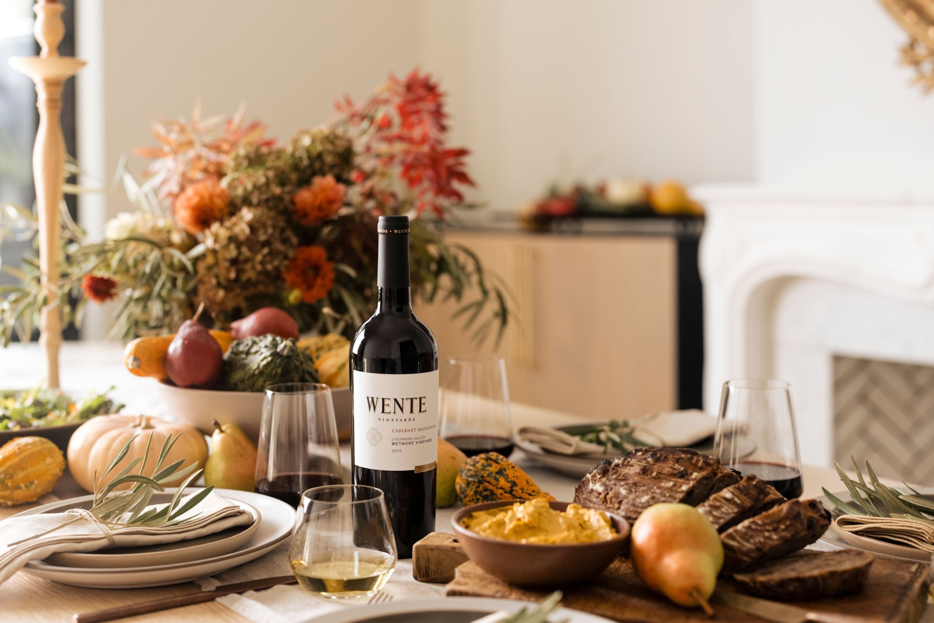 a bottle of wine on a table spread with food