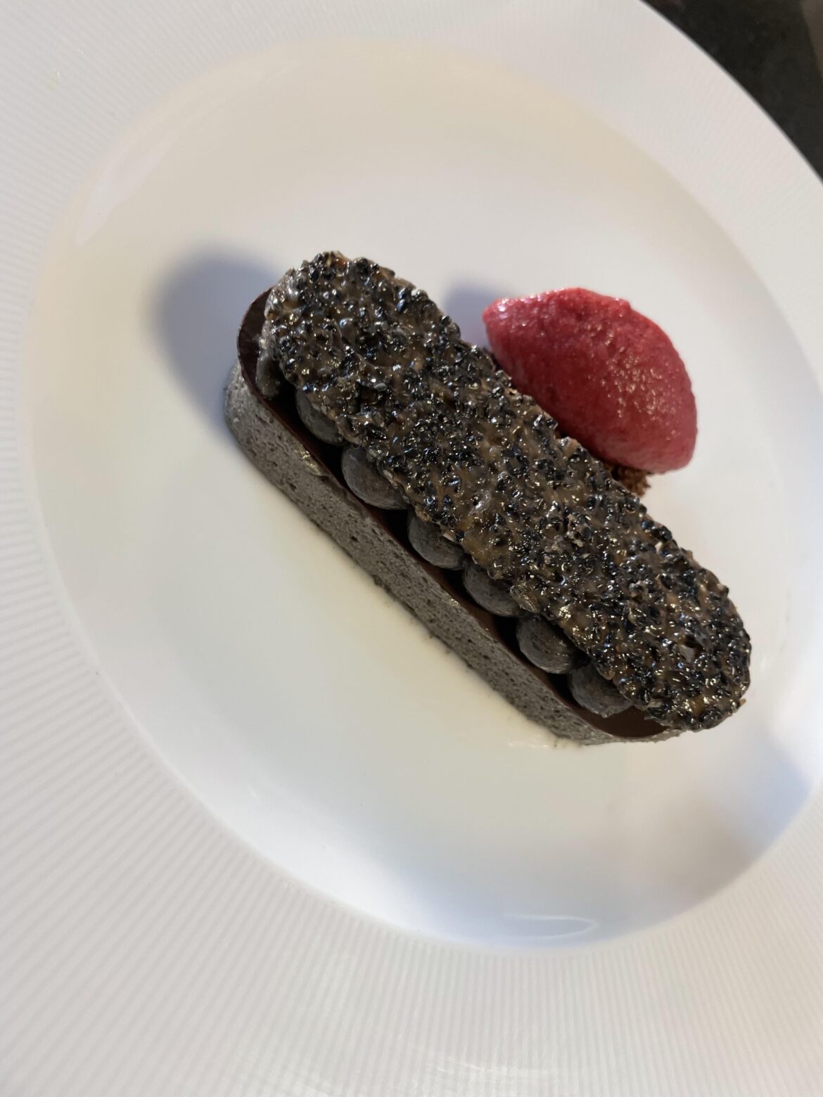 iced black sesame parfait cherry jam insert , tempered chocolate, black sesame cremeux , black sesame tulie, coco crumb cherry sorbet