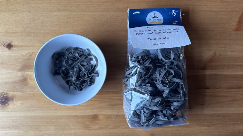 Antignano Tagliatelle with Cuttlefish Ink on wooden table