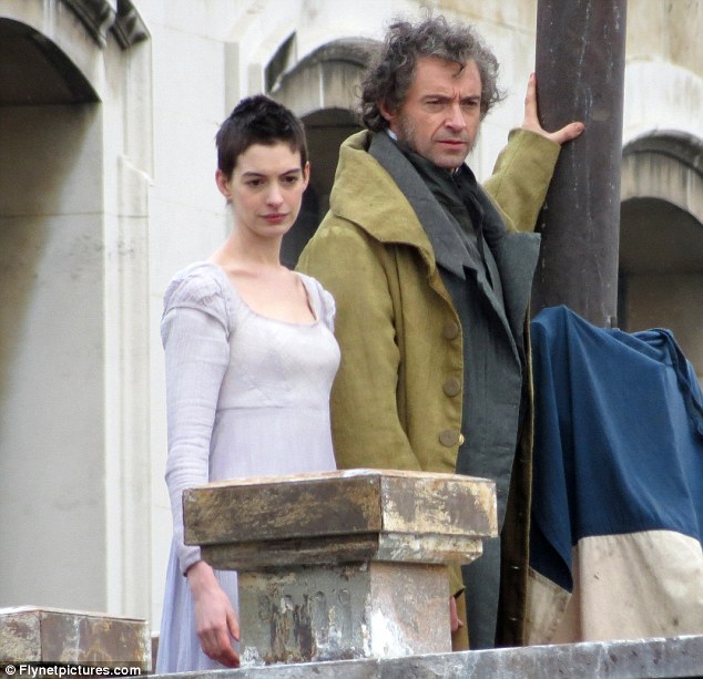 Can you hear the people sing? Hugh and Anne Hathaway on the London set of Les Miserables coming out in December