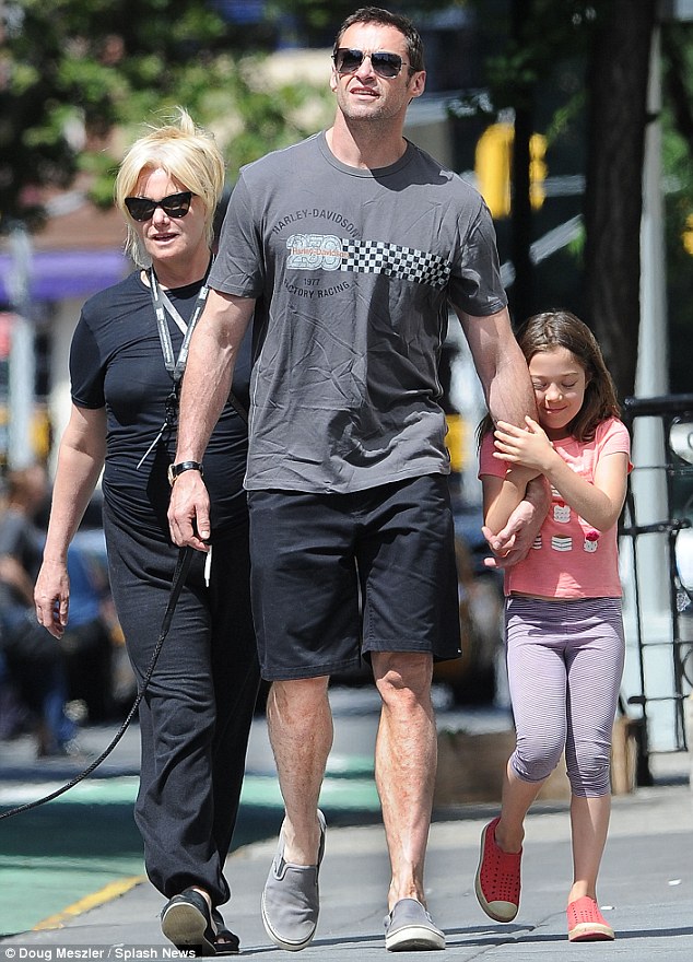 Dady's girls: Eva was seen snuggling her famous father's arm as Hugh's wife of 16 years walked closely behind them