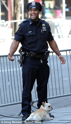 Privileged pooch: Jackman's two-year-old French bulldog Dali savoured the attention from his two personal armed NYPD officers