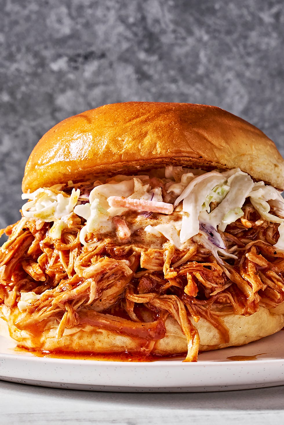 brown sugar bbq chicken in a sandwich with slaw