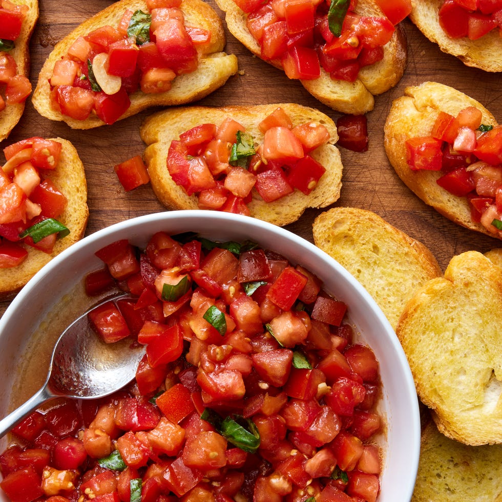 bruschetta spooned on top of slices of a toasted baguette