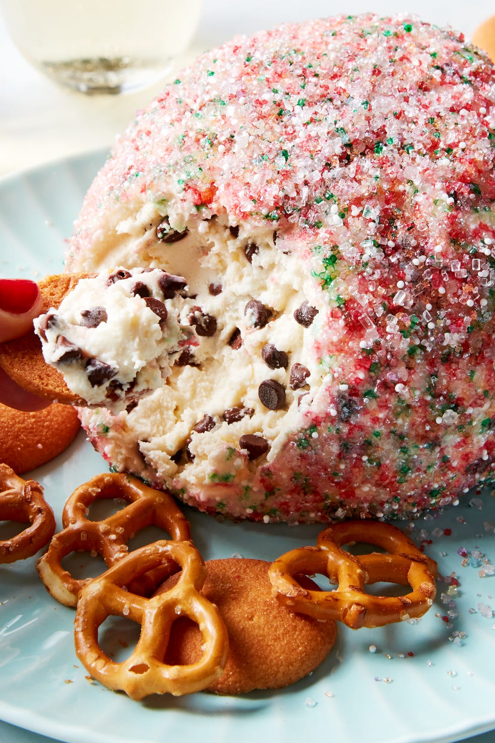 chocolate chip cookie dough ball rolled in sprinkles served with pretzels and nilla wafers