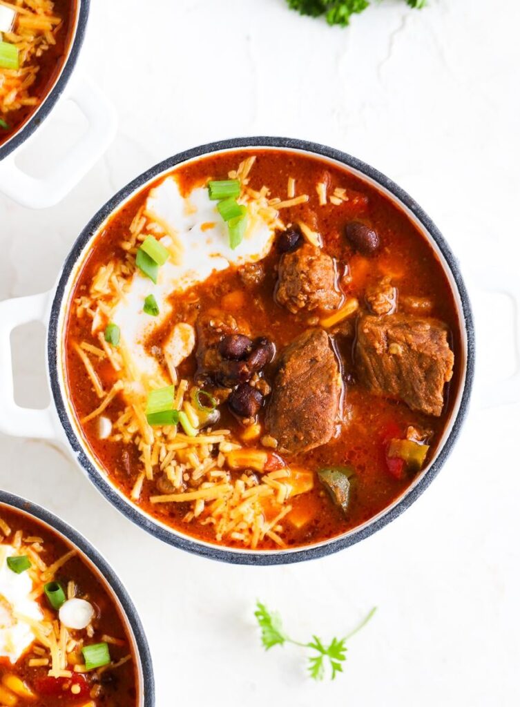 [OC] Steak and Ground Beef Chili topped with Cheddar Cheese, Sour Cream, and Green Onions