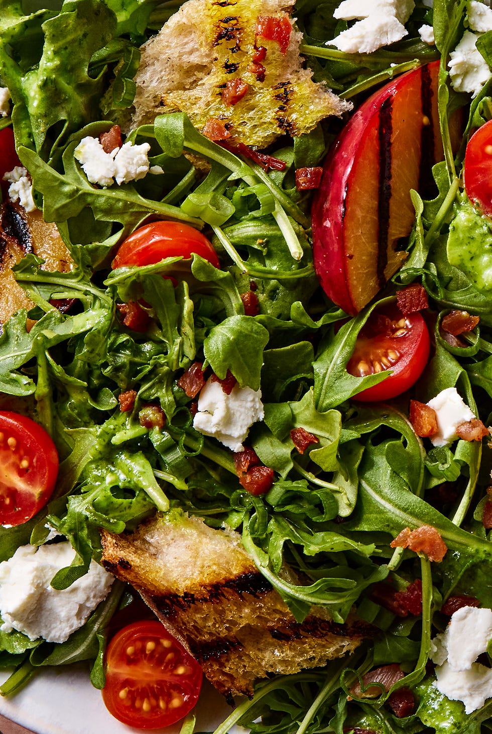 grilled plums tossed with crispy pancetta, tangy goat cheese﻿, fresh cherry tomatoes, and grilled sourdough bread, then drizzled with a maple dijon dressing