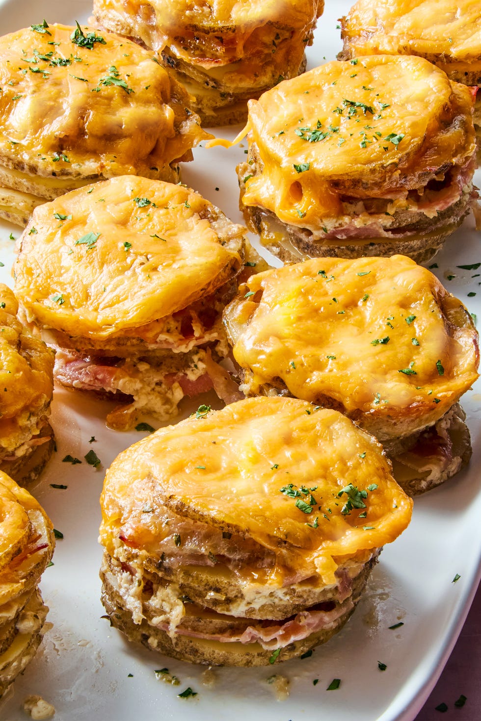 layers of russet potatoes soaked in fresh thyme, seasoned half and half, and parmesan layered thinly sliced ham and topped each with melty cheddar cheese