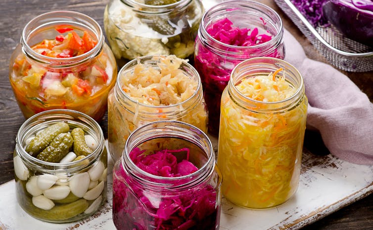 Brightly coloured pickles and sauerkraut in jars