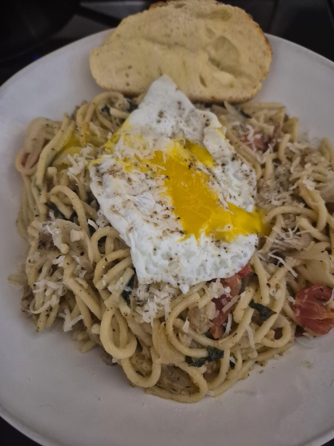 Runny egg on leftover spaghetti with clams
