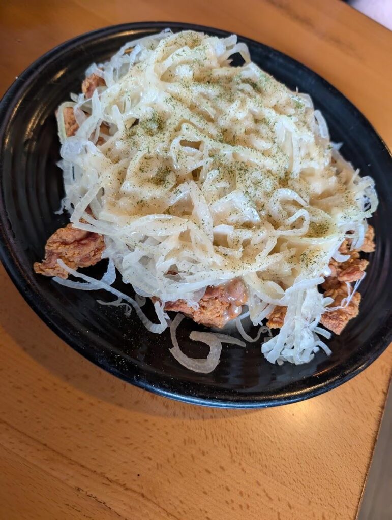 The Korean place near me is serving fried chicken absolutely drowned in white onion in a thick honey sauce