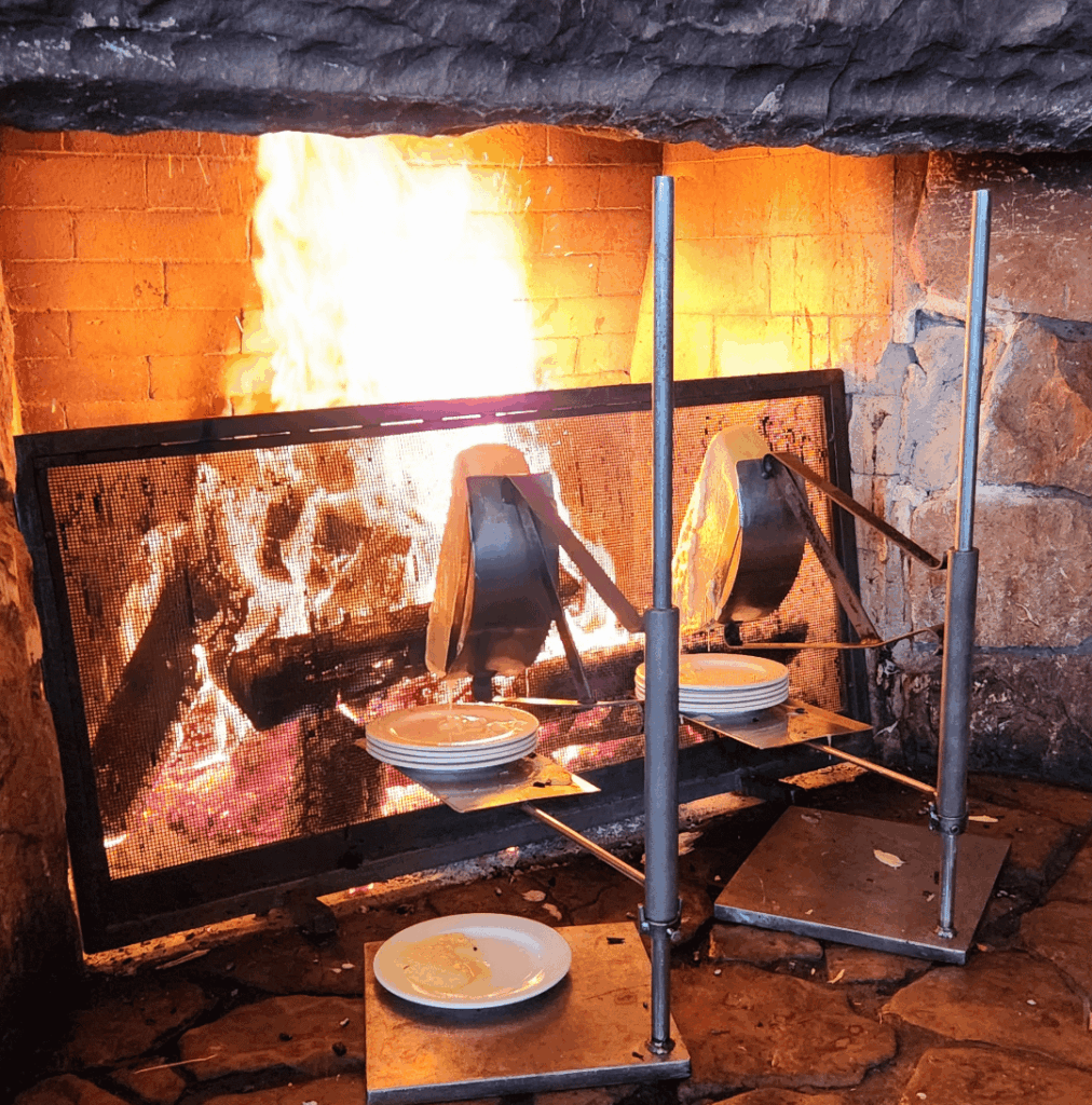 Raclette melting in front of an open fire