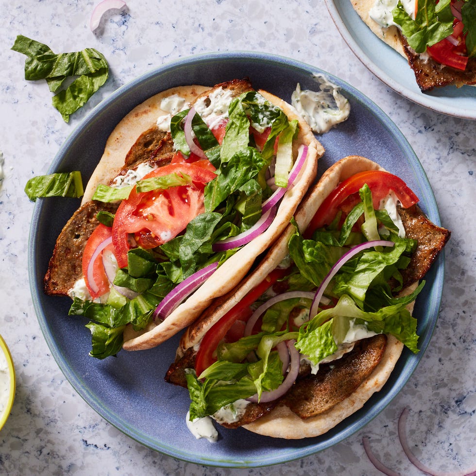 gyro sandwich with lamb, tzatziki, lettuce, tomato and onion in a pita