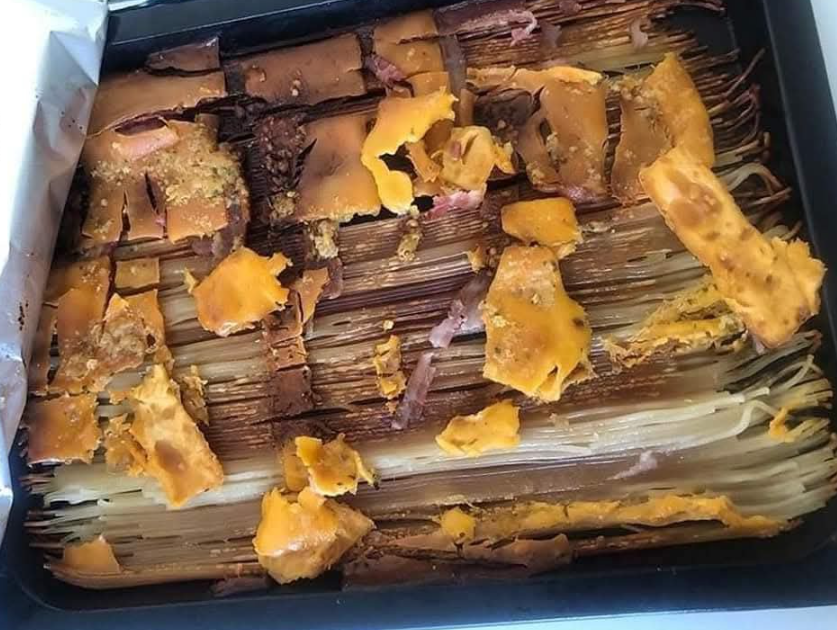 A failed attempt at an Italian dish, showing burnt and overcooked pasta.