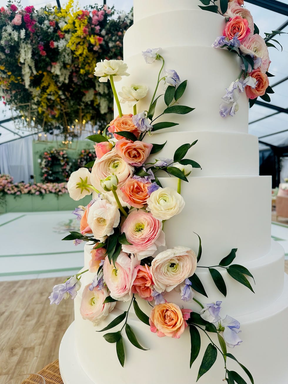 elegant wedding cake adorned with fresh flowers