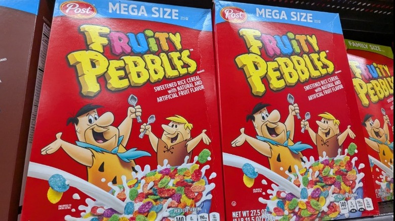 Mega sized boxes of Fruity Pebbles cereal placed next to each other on grocery shelf