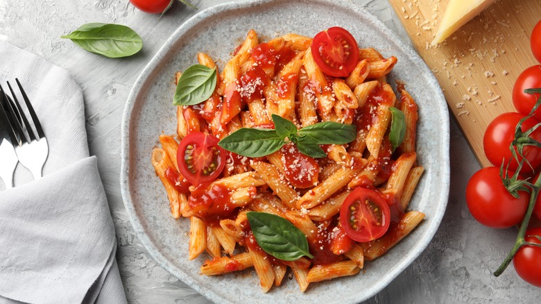 Pasta with fresh tomatoes, basil, and parmesan cheese on a plate